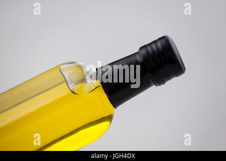 Cropped image of oil bottle against wall Stock Photo