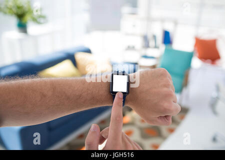 Male executive using smartwatch in the office Stock Photo