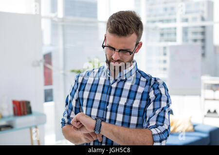 Male executive using smartwatch in the office Stock Photo