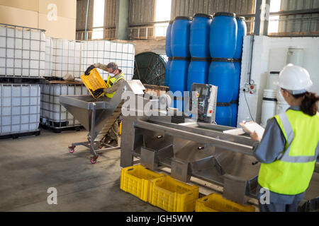 Technician and worker working together in oil factory Stock Photo