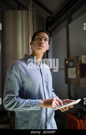 Manager using digital tablet in warehouse of restaurant Stock Photo