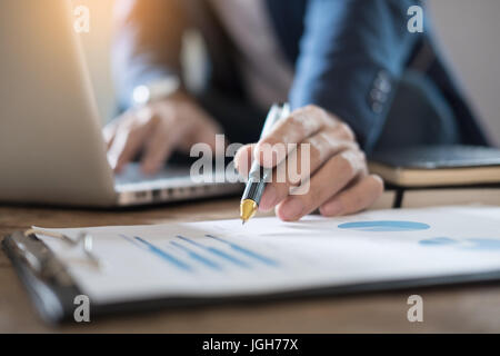 Business Man Studying accountant working with financial data Graph Report Concept. Stock Photo
