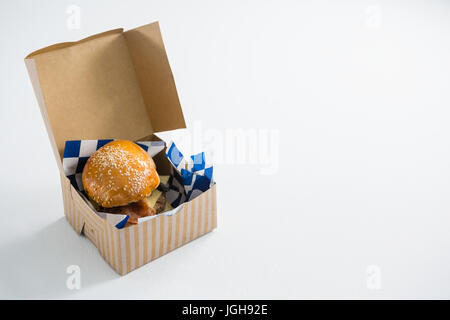 High angle view of cheeseburger in box on white table Stock Photo