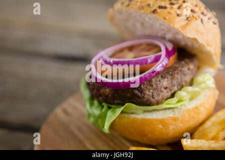 High angle view of onion and tomato in hamburger on cutting board Stock Photo