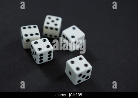 Close-up of white dices on black background Stock Photo