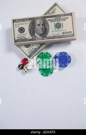 US dollars, dice and casino chips arranged on white background Stock Photo