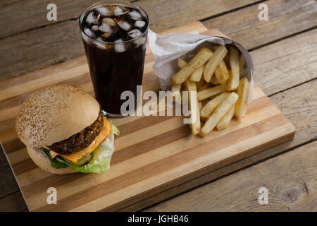 Overhead of hamburger, french fries and cold drink on table Stock Photo