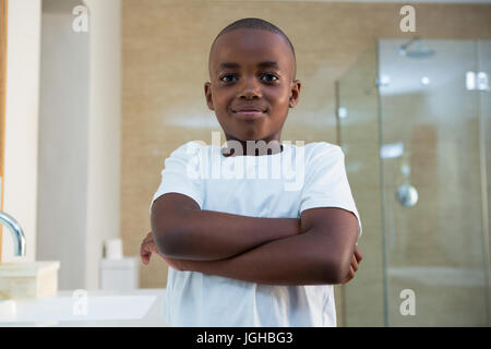 Portrait of smiling boy standing in domestic bathroom Stock Photo