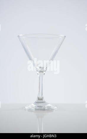 Close-up of empty martini glass on table against white background Stock Photo