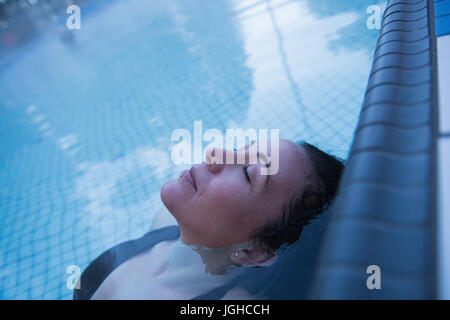 Young woman relaxing in the swimming pool Stock Photo - Alamy