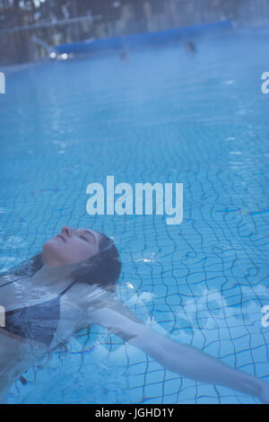 Young woman relaxing in the swimming pool Stock Photo - Alamy