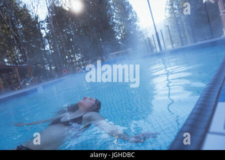 Woman relaxing in swimming pool, portrait Stock Photo - Alamy