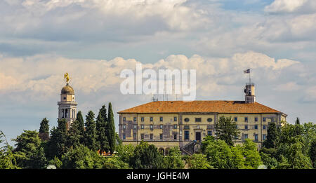 View from castle of Udine, belfry with golden angel and cloudy sky. Stock Photo