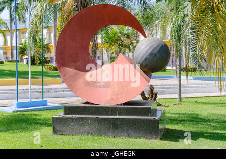 PORTO VELHO, BRAZIL - JUNE 15, 2017: Sculpture in front of the city hall of Porto Velho, surrounded by grass and trees. Red sculpture made of metal, r Stock Photo