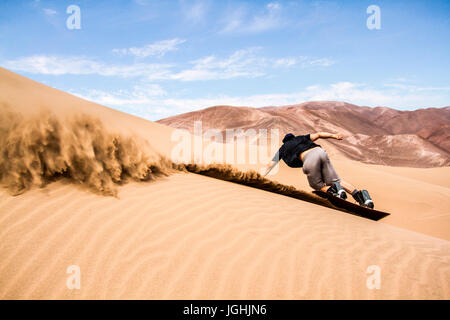 Sandboarding on Atacama Desert. Iquique, Tarapaca Region, Chile. 14.11.15 Stock Photo
