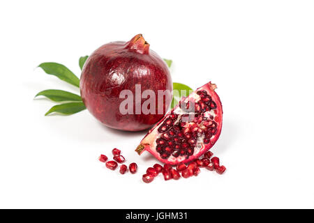 Fresh Pomegranate sliced with seeds on isolated white background Stock Photo