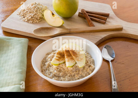 Oatmeal with apples and cinnamon in a white bowl Stock Photo