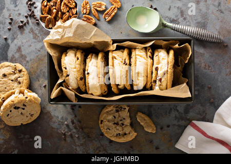 Ice cream sandwiches with nuts and caramel and chocolate chip cookies overhead shot Stock Photo