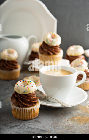 Coffee and cream cupcakes decorated with donuts Stock Photo