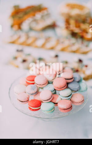 The composition of the colourful macarons placed on the plate stand. Stock Photo