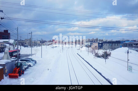 Yoichi, Japan - Feb 4, 2015. Rail tracks with snow at winter in Yoichi, Hokkaido, Japan. Yoichi is the home of the Yoichi distillery owned by Nikka Wh Stock Photo