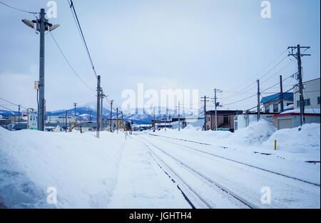 Yoichi, Japan - Feb 4, 2015. Rail tracks with snow at winter in Yoichi, Hokkaido, Japan. Yoichi is the home of the Yoichi distillery owned by Nikka Wh Stock Photo