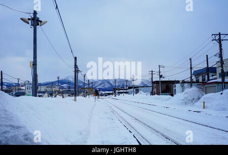 Yoichi, Japan - Feb 4, 2015. Rail tracks with snow at winter in Yoichi, Hokkaido, Japan. Yoichi is the home of the Yoichi distillery owned by Nikka Wh Stock Photo