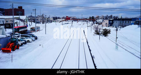 Yoichi, Japan - Feb 4, 2015. Rail tracks with snow at winter in Yoichi, Hokkaido, Japan. Yoichi is the home of the Yoichi distillery owned by Nikka Wh Stock Photo