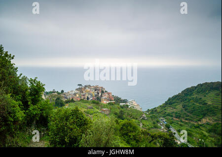 The small village of Corniglia, with its colorful houses surrounded by the vineyards, is one of the five towns of the Cinque Terre in Liguria, Italy. Stock Photo