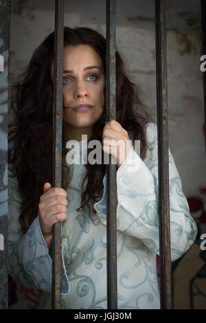Crazy girl behind the bars Stock Photo