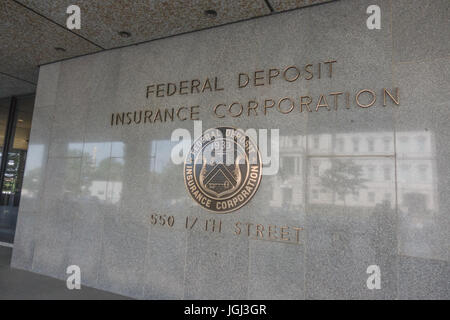 Sign and seal of FDIC - Federal Deposit Insurance Corporation headquarters, across from Executive Office Building (reflecting) in Washington, DC. Stock Photo