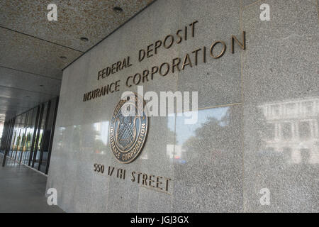 Sign and seal of FDIC - Federal Deposit Insurance Corporation headquarters, across from Executive Office Building (reflecting) in Washington, DC. Stock Photo