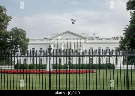 Pow/MIA Flag flies over White House,with American flag; pow/mia flag is raised over White house five days each year, here on Flag Day, June 14, 2017 Stock Photo