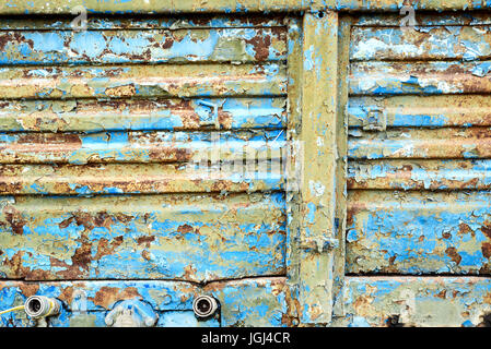 Old corroded blue metal with rust flecks and peeling damaged paintwork Stock Photo