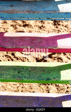 Vibrant faded painted wooden planks of wood in strong sunlight Stock Photo