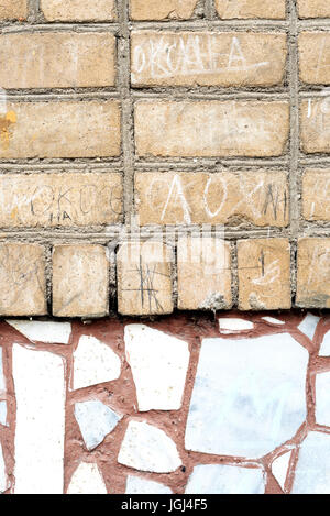 Old faded brick wall with a crazy paving style tiling of light brickwork. Copyspace area for vintage and construction based ideas Stock Photo