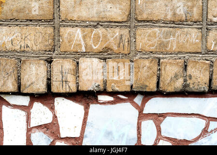 Old faded brick wall with a crazy paving style tiling of light brickwork. Copyspace area for vintage and construction based ideas Stock Photo