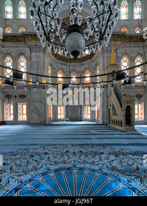Interior shot of Nuruosmaniye Mosque, an Ottoman Baroque mosque, overlooking niche (Mihrab) and marble minbar (Platform) facade with many colored stai Stock Photo
