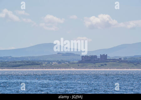 Bamburgh Castle heat haze. THis north east UK castle appears to shimmer in the heat of a June day Stock Photo