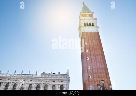 Saint Mark bell tower in the center of Venice with golden angel statue at the top and beautiful clouds Stock Photo