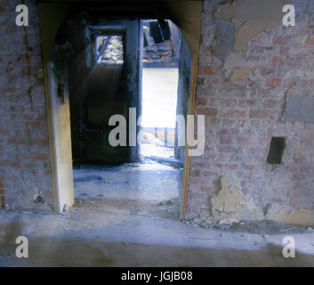 interiors of decaying industrial spaces for survival games. door in an abandoned room Stock Photo