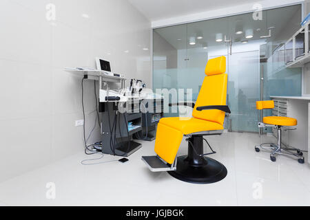 Stylish bright orange armchair in the dentist's office Stock Photo