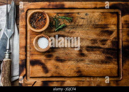 Cooking background concept. Vinrage cutting board, cutlery and spices. Top view Stock Photo