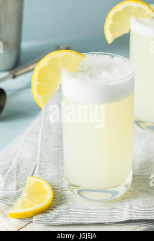Refreshing Cold Egg Gin Fizz with a Lemon Garnish Stock Photo