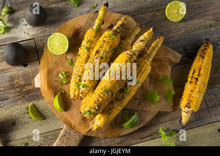 Barbecued Homemade Elote Mexican Street Corn with Mayo and Chili Powder Stock Photo