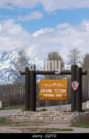 Grand Teton National Park sign with mountains in background east of park Stock Photo