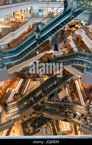Escalators and shoppers at a shopping mall in Hong Kong SAR Stock Photo