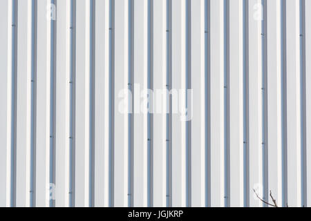 Silver-colored metal wall corrugated sheet metal background. Stock Photo