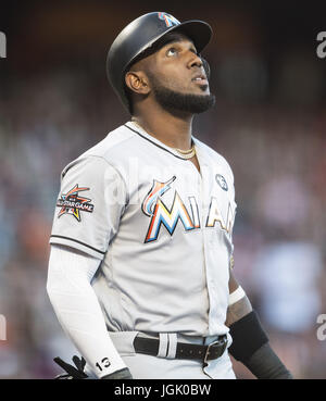 Miami Marlins' Marcell Ozuna (13) is met in the dugout after hitting a ...