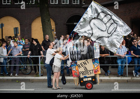 Hamburg, Germany 08th July 2017. Rent a protest handing out placards ahead of the anti-G20 demonstration. Hamburg, Germany 2017. Andy Barton/ Alamy Live News Stock Photo